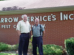Two men smiling for a photo in front of Arrow Services, Inc. | Exterminators Indiana